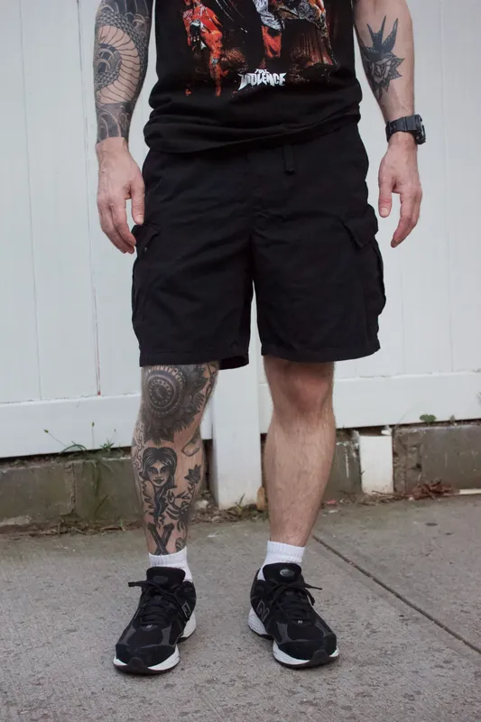 black cargo shorts with black graphic tee