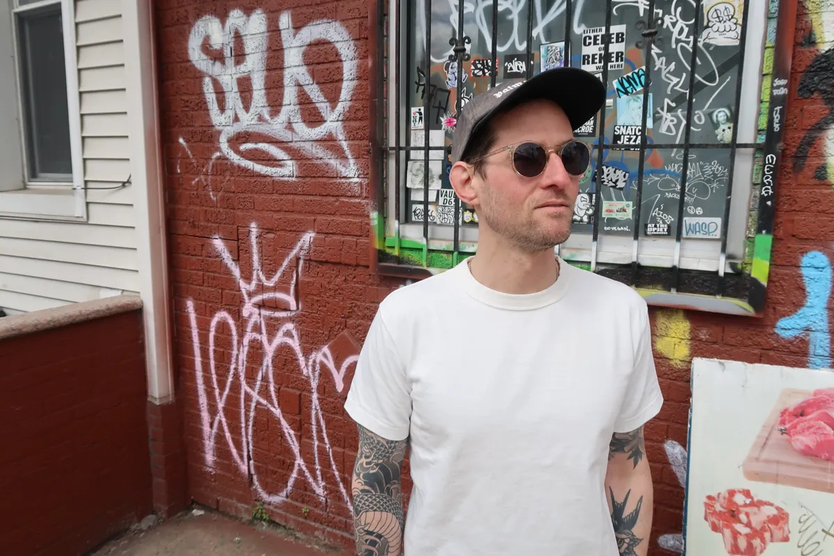 Portrait of the Black Thread Club founder in Brooklyn streetwear style