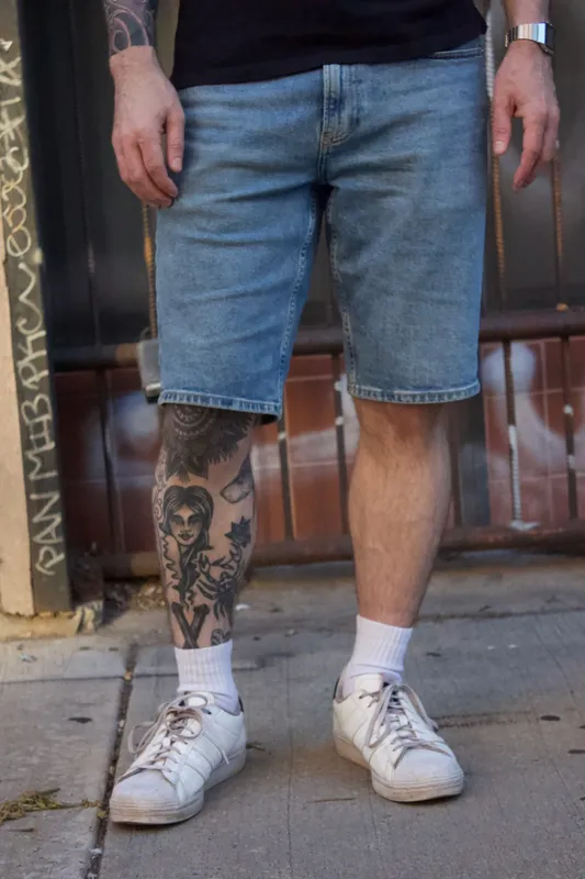 Denim shorts outfit with navy polo shirt closeup